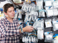 Portrait,Of,Adult,Positive,Male,Choosing,Electrical,Installation,Products Portrait of adult positive male choosing electrical installation products